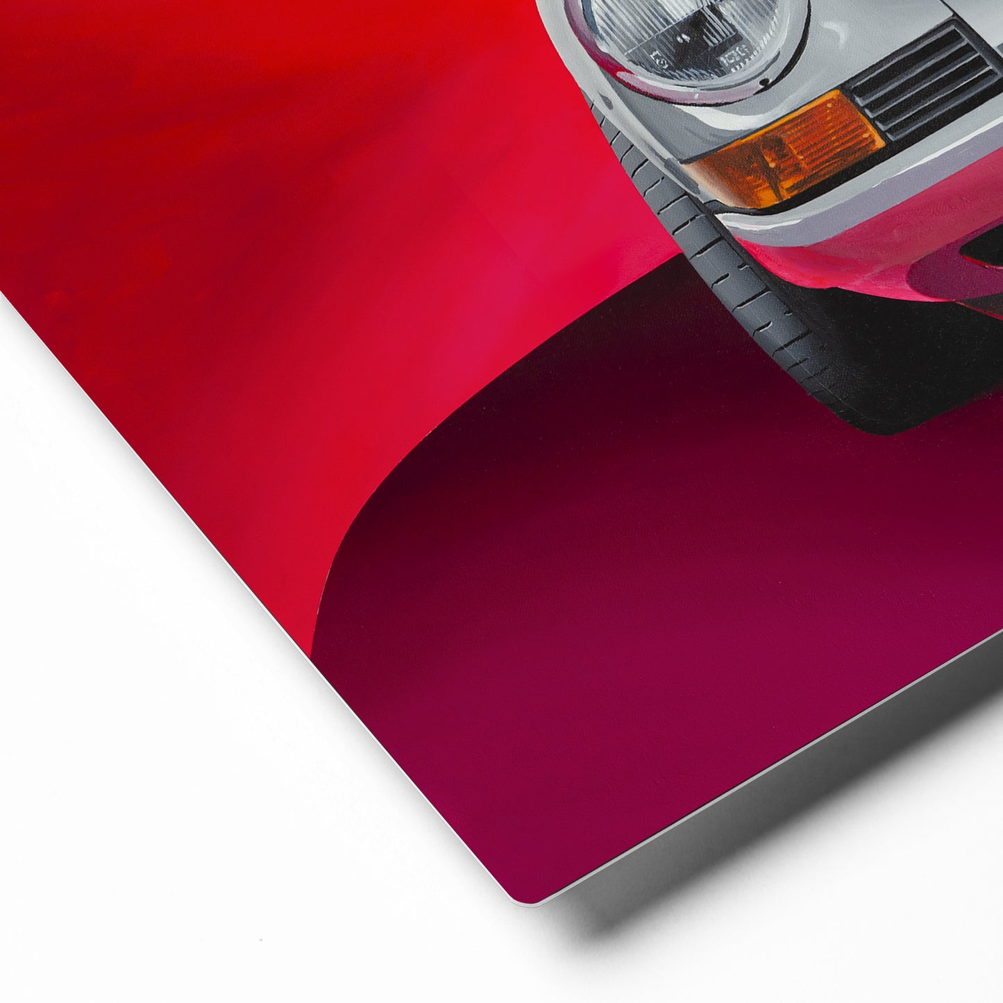 Closeup of product corner showing metal edge. Hand painted silver Porsche 911 against red background